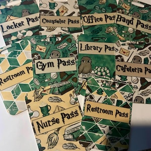 May include: A collection of green and yellow passes with various labels, including "Locker Pass," "Gym Pass," and "Nurse Pass." Each pass features a unique design with illustrations of owls, books, and other themed elements. The passes are rectangular with rounded tops.
