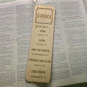 May include: A wooden bookmark with the name "RODERICK" and inspirational text from the Bible. The bookmark features the phrases "you are... STRONG, CHOSEN, MADE FOR A PURPOSE, A PRECIOUS CHILD OF GOD, LOVED FOREVER" and Bible verses.