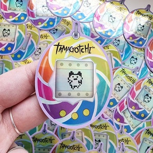 Tamagotchi Holographic Sticker – Retro Virtual Pet Vinyl Decal
