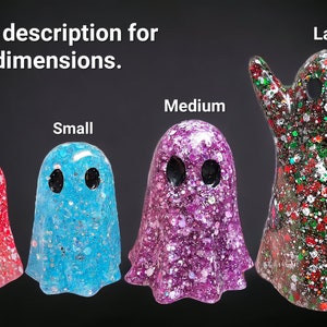 May include: Four glittery ghost figurines in red, blue, purple, and green, each with black eye cutouts. The text "See description for dimensions" is at the top. The ghosts are labeled "Classic", "Small", "Medium", and "Large".