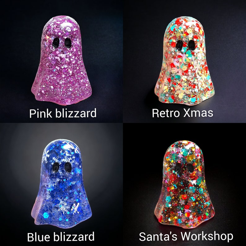 May include: Four colorful ghost-shaped resin figurines. The ghosts are pink, blue, and multi-colored with glitter and the text "Pink blizzard", "Retro Xmas", "Blue blizzard", and "Santa's Workshop". Each ghost has two black eye holes.