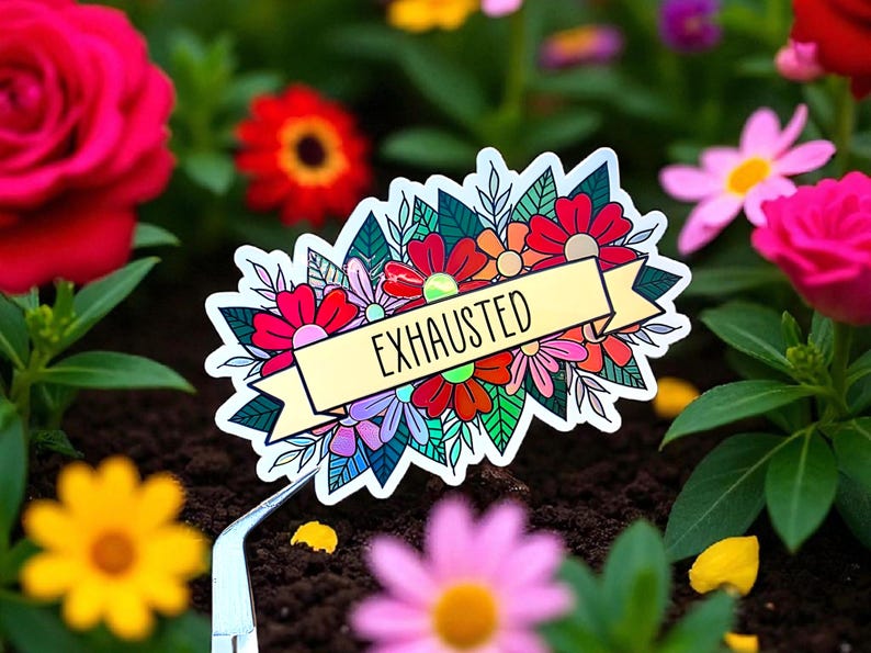May include: A colorful sticker featuring a floral design with the word "EXHAUSTED" on a banner. The sticker is surrounded by various flowers in a garden setting, including red, pink, and yellow blooms.