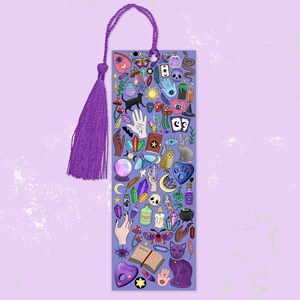 May include: A purple bookmark with a matching tassel. The bookmark is covered in colorful illustrations of mystical items, including a black cat, crystals, a Ouija board, and a spell book. The bookmark is designed for book lovers and those interested in the occult.