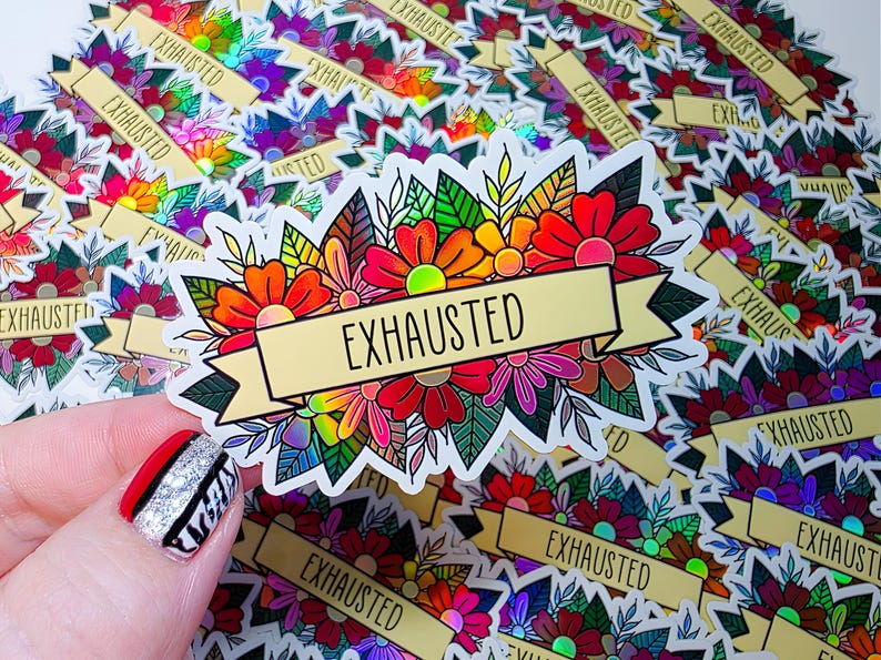 May include: A sticker with a floral design in red, orange, pink, and yellow, with green leaves. The word "EXHAUSTED" is written on a gold banner across the flowers. Other stickers with the same design are in the background.