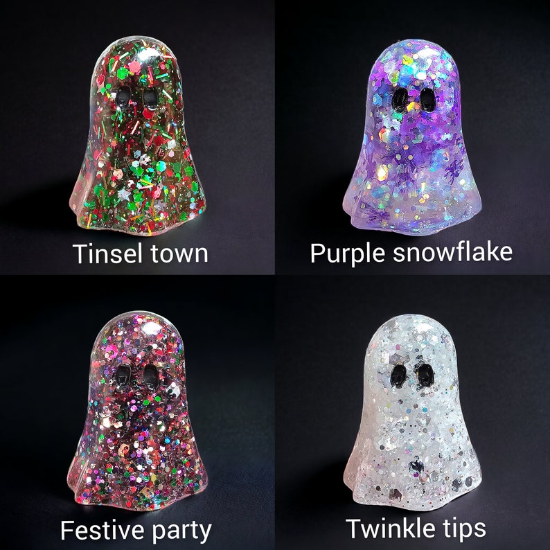 May include: Four resin ghost figurines with glitter and text. The ghosts are in the colors of red, green, purple, and white. The text reads "Tinsel town", "Purple snowflake", "Festive party", and "Twinkle tips".