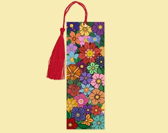 May include: A rectangular bookmark featuring a vibrant floral design in various colors, including red, yellow, blue, and purple. The bookmark has a red tassel attached to the top with a matching red cord.