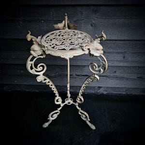 Victorian brass plant table, gold plant stand, brass side table, brass coffee table with lacy botanical decorations and lion paws legs.