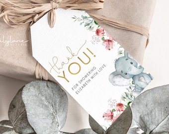 Op de afbeelding: Witte bedankkaart met gouden tekst "Thank You!" en "For showering Elizabeth with love". De kaart heeft een aquarel-illustratie van een baby-olifant met roze bloemen en groen.