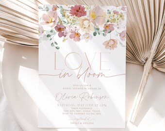 May include: A bridal shower invitation featuring a floral design. The invitation reads "Love in Bloom" and includes the name "Olivia Robinson". The invitation details the date, time, and location of the shower. It also includes the text "Registered at Target & Amazon".