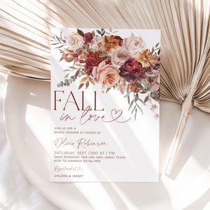 May include: Fall in love bridal shower invitation with a floral design featuring burgundy, peach, and cream roses, greenery, and fall leaves. The invitation includes the text "Fall in love" and details for the event, including the date, time, location, and RSVP information. The text "Registered at Amazon & Target" is also included.