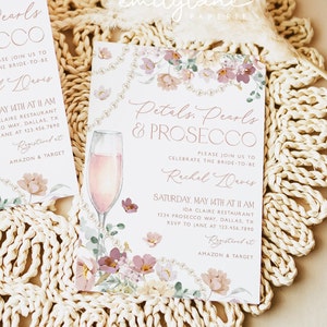 May include: A bridal shower invitation with a floral design and a glass of pink champagne. The invitation reads "Petals, Pearls & Prosecco" and invites guests to celebrate the bride-to-be, Rachel Davis. The event will be held on Saturday, May 14th at 11 AM at Ida Claire Restaurant. RSVP to Jane at 123.456.7890. Registered at Amazon & Target.