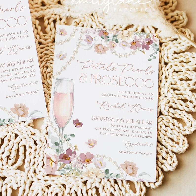 May include: A bridal shower invitation with a floral design and a glass of pink champagne. The invitation reads "Petals, Pearls & Prosecco" and invites guests to celebrate the bride-to-be, Rachel Davis. The event will be held on Saturday, May 14th at 11 AM at Ida Claire Restaurant. RSVP to Jane at 123.456.7890. Registered at Amazon & Target.