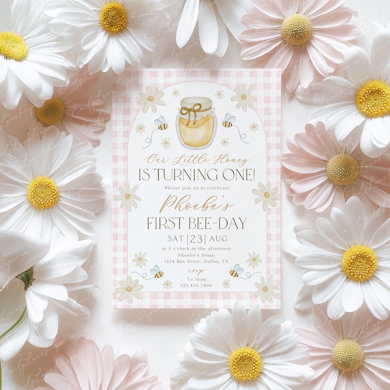 May include: A baby shower invitation with a honeybee theme. The invitation features a jar of honey, bees, and daisies on a pink gingham background. The text reads "Our Little Honey is Turning One!" and "Phoebe's First Bee-Day."
