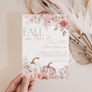 May include: Fall in love bridal shower invitation with a watercolor floral design featuring pumpkins and a heart. The invitation is printed on white cardstock and has a pink and gold color scheme. The text on the invitation reads "Fall in love" and "Join us for a bridal shower in honor of Olivia Robinson".