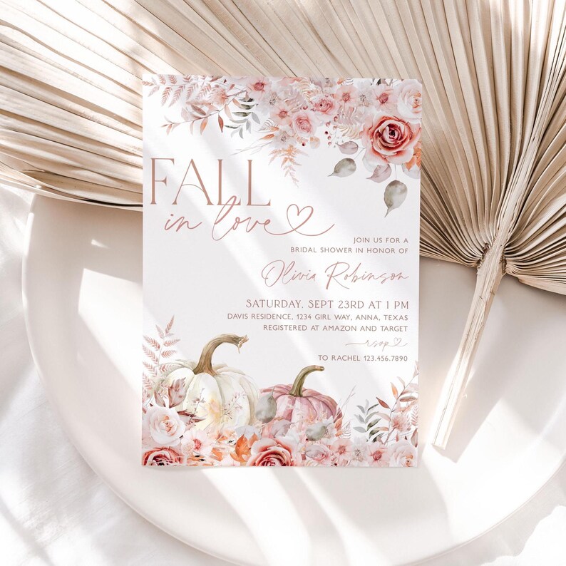 May include: Fall in love bridal shower invitation with a watercolor floral design featuring pumpkins and roses in shades of pink, peach, and white. The invitation includes the text "Fall in love" and "Olivia Robinson".