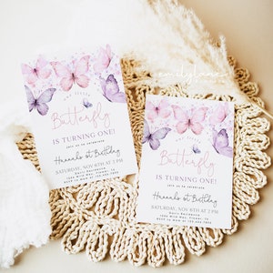 May include: Two purple and pink butterfly themed first birthday party invitations with watercolor butterflies and the text "Our little butterfly is turning one!" and "Hannah's 1st Birthday" with details for the party.