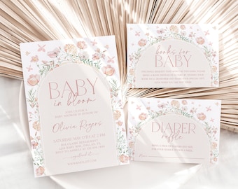 May include: A pink and green floral baby shower invitation with a white arch and the text "Baby in Bloom" and "Olivia Rogers". The invitation also includes the date, time, and location of the shower. There are two additional cards with floral designs and the text "Books for Baby" and "Diaper Raffle".