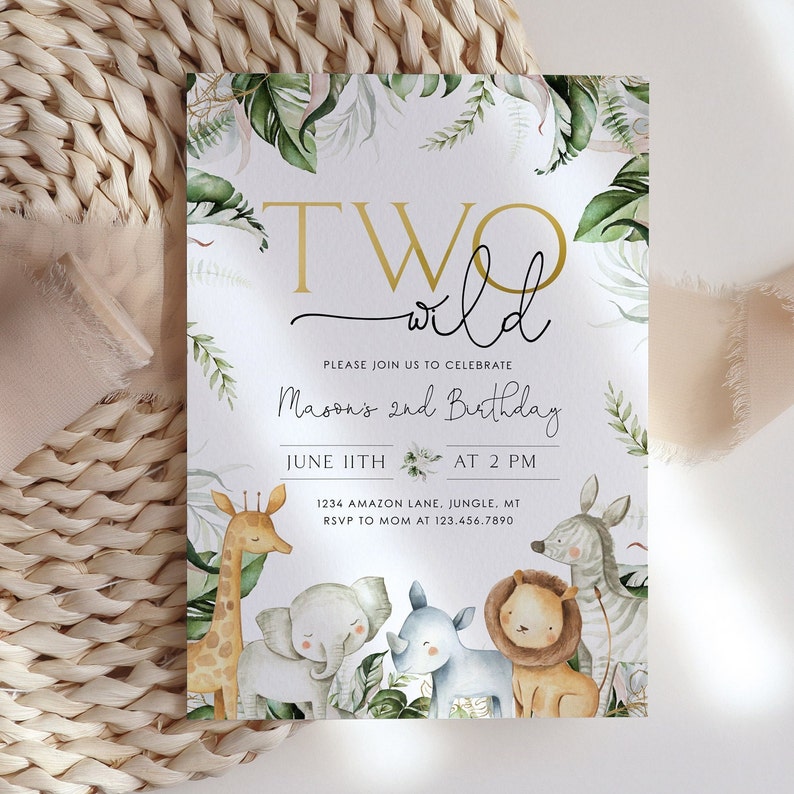 May include: A white invitation card with green leaves and jungle animals. The text reads "Two Wild" and "Mason's 2nd Birthday". The date and time of the party are June 11th at 2 PM. The address is 1234 Amazon Lane, Jungle, MT. The RSVP number is 123.456.7890.