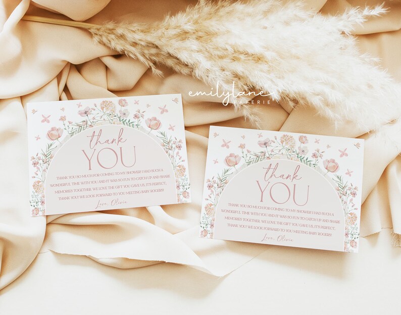 May include: Two pink and white floral thank you cards with a pink floral arch and the text "Thank You" in a pink script font. The text below the arch reads "Thank you so much for coming to my shower! I had such a wonderful time with you, and it was so fun to catch up and make memories together. We love the gift you gave us, it's perfect. Thank you, we look forward to you meeting baby [baby's name]. Love, Olivia."
