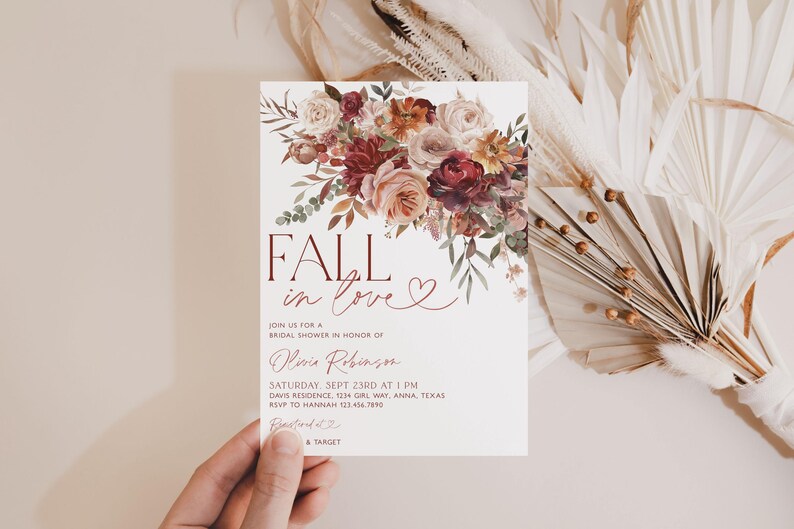 May include: Fall in love bridal shower invitation with a watercolor floral design in shades of burgundy, pink, and cream. The invitation features the text "Fall in love" with a heart.