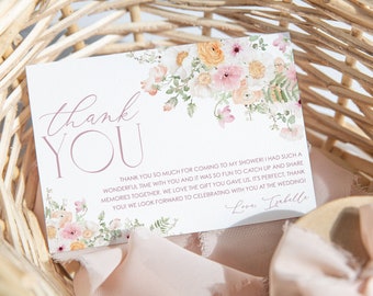May include: A white thank you card with pink and peach watercolor flowers. The text reads "Thank You" in a pink script font and includes a message thanking guests for attending a bridal shower and the gift they gave. The card is signed "Love, Isabelle".