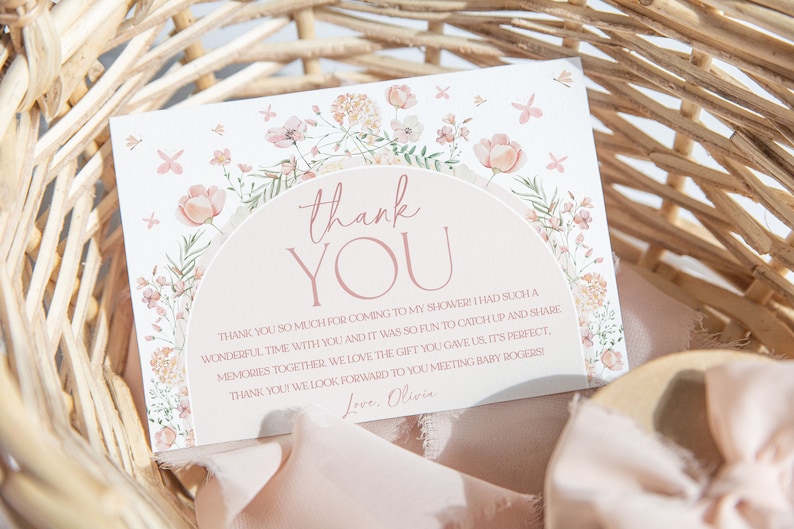 May include: A thank you card with a floral design and the text "thank you" in pink. The card has a message thanking guests for attending a baby shower and includes the name "Olivia".
