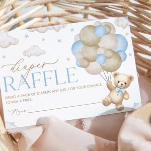 May include: A blue and brown diaper raffle ticket with a teddy bear holding balloons. The text reads "diaper raffle" and "Bring a pack of diapers any size. For your chance to win a prize."