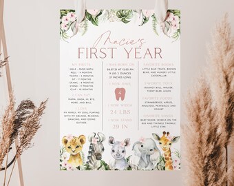 Może przedstawiać: Drukowana karta w kolorze różowym i białym z motywem zwierząt dżungli. Karta nosi tytuł "Thacie's First Year" i zawiera informacje o pierwszym roku życia dziecka, takie jak data urodzenia, waga, wzrost i ulubione rzeczy. Karta jest ozdobiona ilustracjami lwa, zebry, nosorożca, słonia i żyrafy.