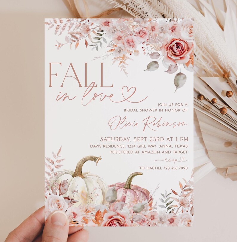May include: Fall in love bridal shower invitation with a watercolor floral design featuring pumpkins and leaves in shades of pink, peach, and green. The invitation includes the text "Fall in love" and "Olivia Robinson".