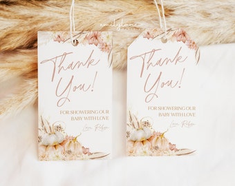 May include: Two white thank you tags with a floral design and the text "Thank You!"  The text "For showering our baby with love" is below the greeting. The text "Love, [Name]" is at the bottom of the tag.