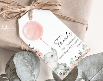 May include: A white thank you tag with a pink balloon, a grey elephant holding the balloon string, and green and pink floral accents. The text on the tag reads "Thanks for showering Savannah with love 11.06.21".