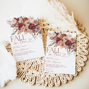 May include: Fall in love bridal shower invitation with a watercolor floral design in shades of pink, red, and orange. The invitation features the text "Fall in love" with a heart symbol. The invitation also includes the bride's name, the date and time of the shower, the location, and RSVP information.