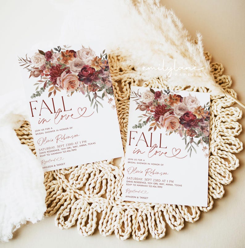 May include: Fall in love bridal shower invitation with a watercolor floral design in shades of pink, red, and orange. The invitation features the text "Fall in love" with a heart symbol. The invitation also includes the bride's name, the date and time of the shower, the location, and RSVP information.