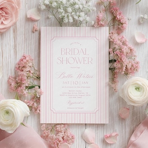 May include: A pink and white striped bridal shower invitation with the text "BRIDAL SHOWER" and "Bella Watson". The invitation is surrounded by pink flowers, white flowers, and pink petals on a light wood surface.