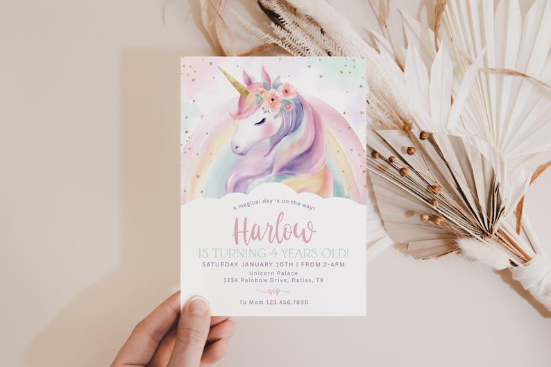 May include: A pastel-colored invitation card featuring a watercolor unicorn with a floral crown and a rainbow. The text reads "Harlow is turning 4 years old!" with event details. The card is held by a hand.