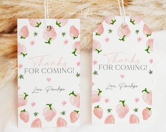 May include: Two white gift tags with a strawberry design. The tags have the text "Thanks for Coming!" in pink script, with a heart and the name "Love, Penelope". The tags are decorated with pink strawberries and green leaves.