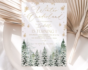 May include: A white invitation with gold lettering for a first birthday party. The invitation features a winter wonderland theme with a snowy forest scene and the text "Winter Onederland" and "Isabelle is turning 1".