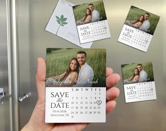 May include: Square magnets with a photo of a couple in a field, with the text "Sophia & Noah" and "Save the Date" with a calendar. The date is May 16, 2026, in Houston, TX. Several magnets are visible.