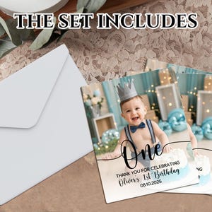 May include: A set of party invitations and envelopes. The invitations feature a baby wearing a crown and the text "One" and "Thank you for celebrating Oliver's 1st Birthday 08.10.2025". The envelopes are white.