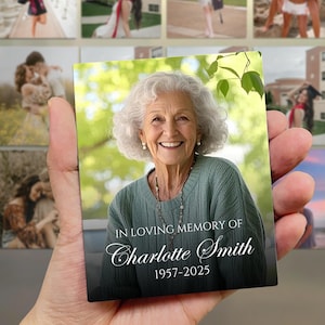 May include: A rectangular magnet featuring a portrait of an elderly woman with white hair, wearing a green top and a necklace. The magnet reads "IN LOVING MEMORY OF Charlotte Smith 1957-2025".