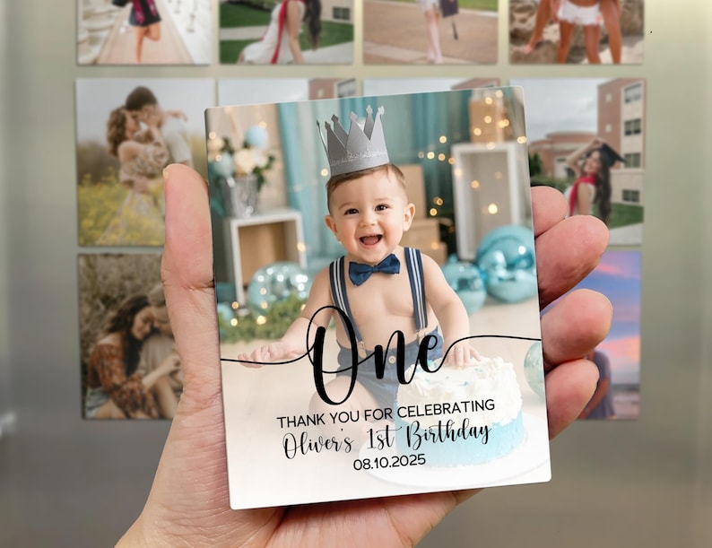 May include: A rectangular photo magnet featuring a smiling baby wearing a crown and bow tie, with the word "One" in script. The text "THANK YOU FOR CELEBRATING Oliver's 1st Birthday 08.10.2025" is also visible.