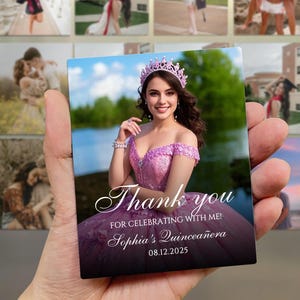 May include: A rectangular magnet featuring a woman in a pink dress and a tiara. The magnet has the text "Thank you for celebrating with me! Sophia's Quincea&ntilde;era 08.12.2025". The background shows a lake and trees.