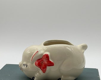 pig planter with a red bow. Vintage May be from the fifties.