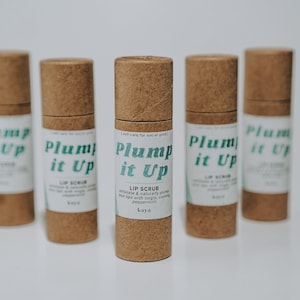 May include: Five brown cardboard tubes with white labels that say "Plump it Up" in green text. The labels also say "Lip Scrub" and "kaya".