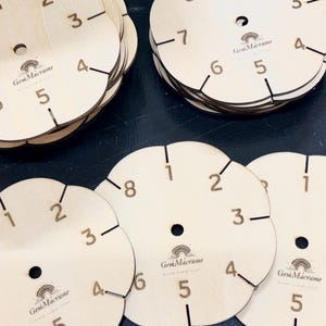May include: Circular light-colored wooden macrame braiding disks featuring laser-engraved numbers one through eight around the perimeter. Each disk has a central hole and notches for cord management, with the GemMacrame logo printed in the center.