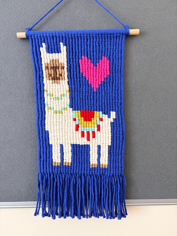 A macrame wall hanging shaped like a llama is a genuinely unexpected twist on the craft — whimsical character art in fiber form.