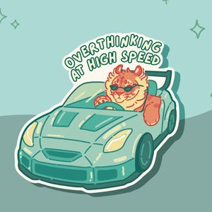 May include: A sticker featuring a cartoon tiger wearing sunglasses and driving a blue sports car. The text "Overthinking at High Speed" is written in green above the car.