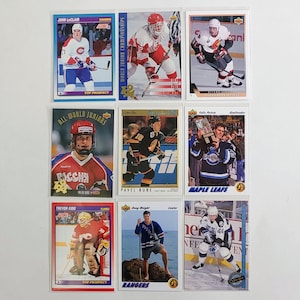 May include: Nine hockey trading cards featuring various players in action. The cards showcase players in team uniforms, action shots, and portraits. Some cards include text such as "TOP PROSPECT", "RANGERS", and player names.