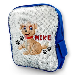 Peut inclure: Sac à dos bleu à paillettes avec un chien de dessin animé et le nom "MIKE" sur le devant. Le sac à dos a une fermeture éclair et une petite poche sur le côté.