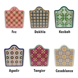 Puede incluir: Seis tablas de cortar diferentes con dise&ntilde;os de azulejos marroqu&iacute;es. Los dise&ntilde;os son de varios colores, incluyendo rojo, verde, azul, amarillo y negro. Las tablas de cortar son todas del mismo tama&ntilde;o y forma, con una parte superior redondeada y una parte inferior plana.